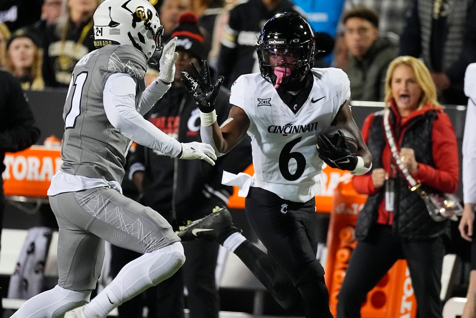 Colorado safety Shilo Sanders, left, pushes Cincinnati running back Evan Pryor out of bounds after catching a pass for a 40-yard gain in the first half of an NCAA college football game Saturday, Oct. 26, 2024, in Boulder, Colo. (AP Photo/David Zalubowski)