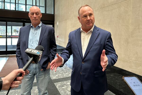 Summit Carbon Solutions CEO Lee Blank, right, talks to reporters, Friday, Nov. 15, 2024, at the state Capitol in Bismarck, N.D., after the state Public Service Commission approved a siting permit for the company's proposed North Dakota route of its planned five-state Midwest carbon dioxide pipeline. At left is Summit Chief Operating Officer Jimmy Powell. (AP Photo/Jack Dura)