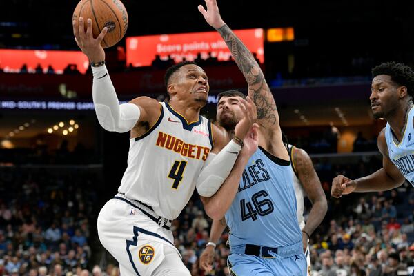 Denver Nuggets guard Russell Westbrook (4) drives against Memphis Grizzlies guard John Konchar (46) in the second half of an Emirates NBA Cup basketball game Tuesday, Nov. 19, 2024, in Memphis, Tenn. (AP Photo/Brandon Dill)