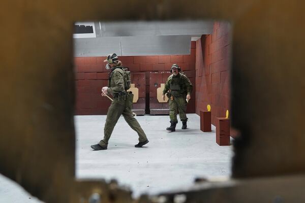 Members of the Vantaa Reservists Association practice at a shooting range in a warehouse in Kerava on the outskirts of Helsinki, Finland Monday, Dec. 2, 2024. (AP Photo/James Brooks)