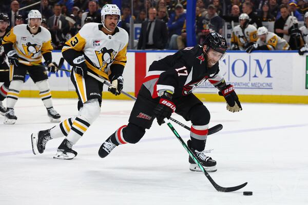 Buffalo Sabres left wing Jason Zucker (17) carries the puck past Pittsburgh Penguins defenseman P.O Joseph (73) during the first period of an NHL hockey game Friday, Jan. 17, 2025, in Buffalo, N.Y. (AP Photo/Jeffrey T. Barnes)