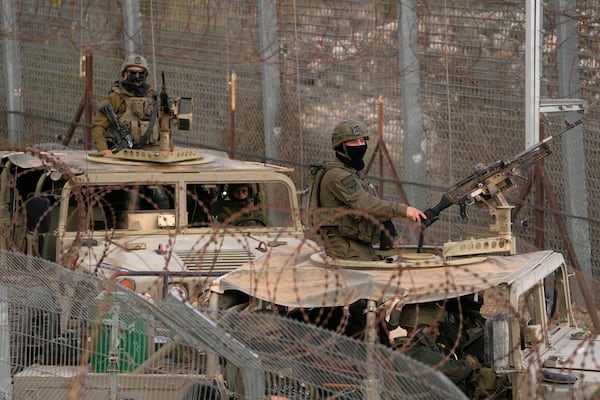 Israeli soldiers stand on armoured vehicles after crossing the security fence near the so-called Alpha Line that separates the Israeli-controlled Golan Heights from Syria, in the town of Majdal Shams, Saturday, Dec. 21, 2024. (AP Photo/Matias Delacroix)