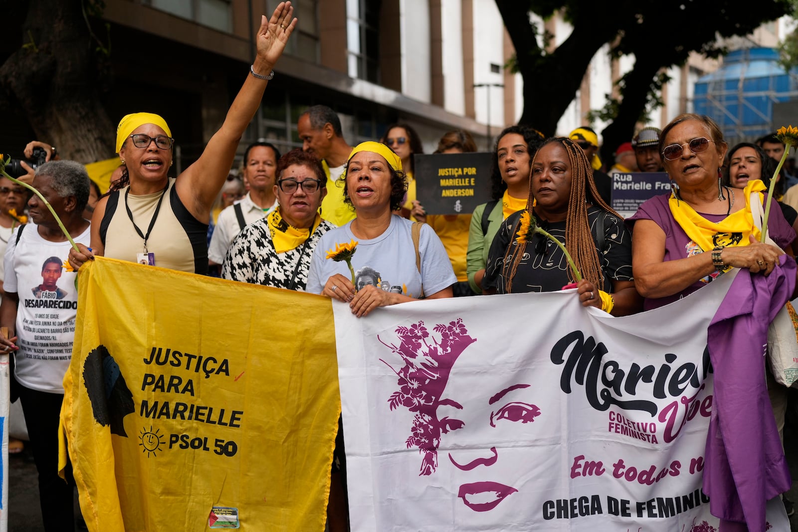 People gather demanding justice before the start of the trial of councilwoman Marielle Franco’s suspected murderers, outside the Court of Justice, in Rio de Janeiro, Brazil, Wednesday, Oct. 30, 2024. (AP Photo/Silvia Izquierdo)