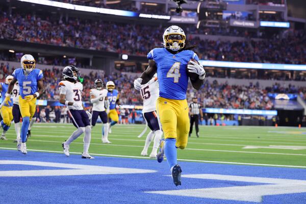 Los Angeles Chargers running back Gus Edwards (4) scores a rushing touchdown during the second half an NFL football game against the Denver Broncos, Thursday, Dec. 19, 2024, in Inglewood, Calif. (AP Photo/Ryan Sun)