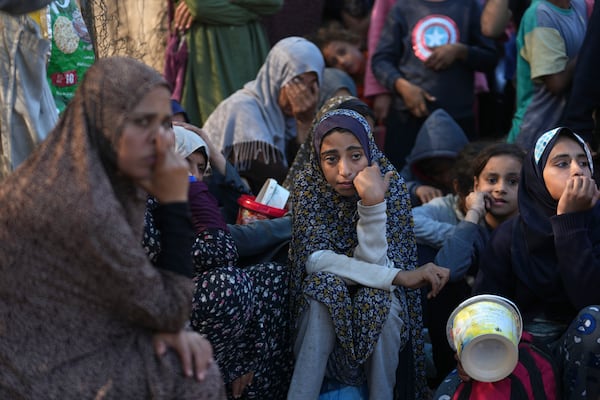 Palestinians queue for food in Deir al-Balah, Gaza Strip, Monday, Nov. 18, 2024. (AP Photo/Abdel Kareem Hana)