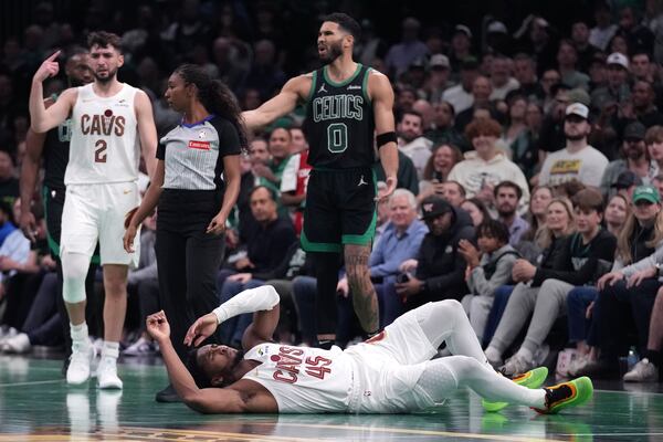 Cleveland Cavaliers guard Donovan Mitchell drops to the floor after colliding with Boston Celtics forward Jayson Tatum (0) during the second half of an Emirates NBA Cup basketball game, Tuesday, Nov. 19, 2024, in Boston. (AP Photo/Charles Krupa)