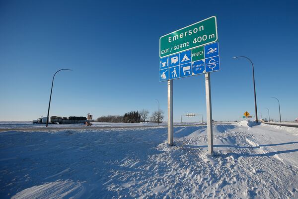 FILE - Road signage is posted just outside of Emerson, Manitoba on Thursday, Jan. 20, 2022. (John Woods/The Canadian Press via AP)