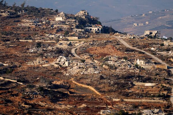 Destroyed buildings in the village of Kfar Kila, southern Lebanon, are seen from northern Israel, Tuesday, Dec. 3, 2024. (AP Photo/Maya Alleruzzo)