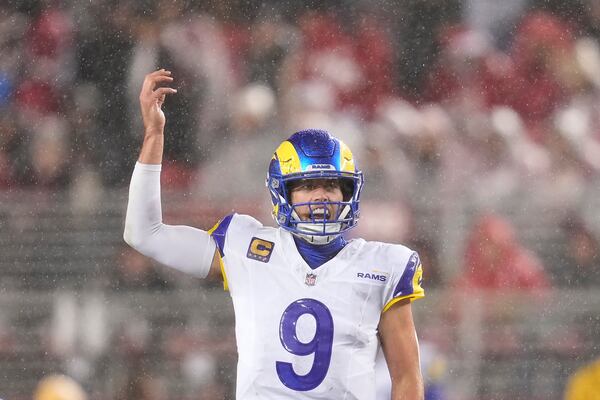 Rain falls as Los Angeles Rams quarterback Matthew Stafford signals at the line of scrimmage during the first half of an NFL football game against the San Francisco 49ers in Santa Clara, Calif., Thursday, Dec. 12, 2024. (AP Photo/Godofredo A. Vásquez)