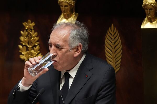 French Prime Minister Francois Bayrou drinks as he delivers his general policy speech, Tuesday, Jan. 14, 2025 at the National Assembly in Paris. (AP Photo/Thibault Camus)