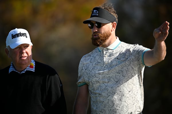 Mark O'Meara, left, and his son Shaun O'Meara talk about their next shot before teeing off on the fifth hole during the first round of the PNC Championship golf tournament, Saturday, Dec. 21, 2024 in Orlando. (AP Photo/Phelan M. Ebenhack)