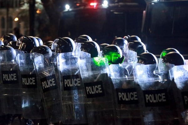 Police blocks a street to stop protesters rallying outside the parliament's building to continue protests against the government's decision to suspend negotiations on joining the European Union in Tbilisi, Georgia, on Monday, Dec. 2, 2024.(AP Photo/Zurab Tsertsvadze)