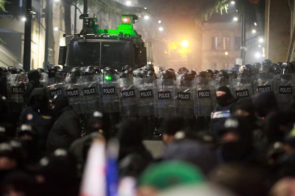 The police block the way to demonstrators during a rally outside the parliament's building to protest the government's decision to suspend negotiations on joining the European Union for four years in Tbilisi, Georgia, on Saturday, Nov. 30, 2024. (AP Photo/Zurab Tsertsvadze)