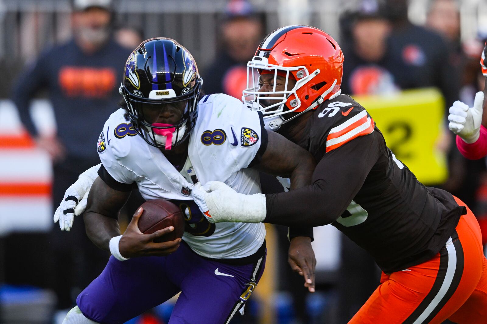 Cleveland Browns defensive end Za'Darius Smith (99) sacks Baltimore Ravens quarterback Lamar Jackson (8) during the second half of an NFL football game in Cleveland, Sunday, Oct. 27, 2024. (AP Photo/David Richard)