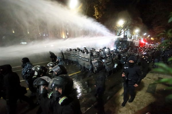 Police use a water cannon to prevent protesters pouring into the streets following Georgian Prime Minister Irakli Kobakhidze's announcement, rallying outside the parliament building in Tbilisi, Georgia, on Friday, Nov. 29, 2024. (AP Photo/Zurab Tsertsvadze)