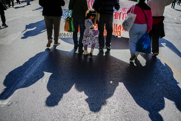 Protesters take part in rally, during a nationwide general strike organized by private and public sector unions demanding for better wages, in Athens, Greece, Wednesday, Nov. 20, 2024. (AP Photo/Thanassis Stavrakis)