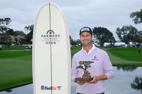 Harris English holds up the trophy after winning the Farmers Insurance Open golf tournament at Torrey Pines Saturday, Jan. 25, 2025, in San Diego. (AP Photo/Denis Poroy)