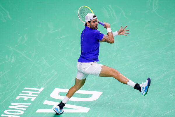 Italy's Matteo Berrettini returns the ball against Australia's Thanasi Kokkinakis during the Davis Cup semifinal at the Martin Carpena Sports Hall in Malaga, southern Spain, on Saturday, Nov. 23, 2024. (AP Photo/Manu Fernandez)