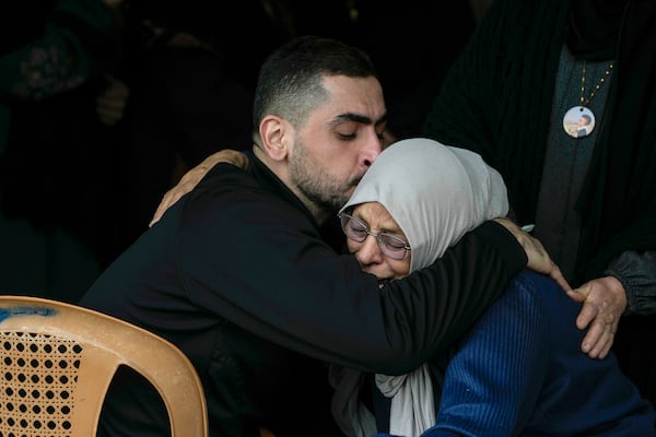 Mourners comfort each other during the funeral of Ahmad Nimer Al-Shaib after he was killed during an Israeli military operation in Jenin, in the West Bank village of Bruqin, Wednesday, Jan. 22, 2025. (AP Photo/Majdi Mohammed)