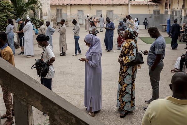 People wait to cast their ballot for legislative elections in Dakar, Senegal Sunday, Nov. 17, 2024. (AP Photo/Annika Hammerschlag)