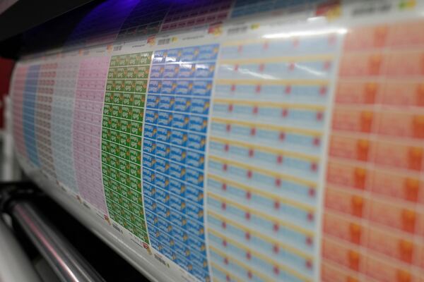 Labels for school children come of the printing machine at 'My Nametags' factory in London, Thursday, Jan. 30, 2025. (AP Photo/Alastair Grant)