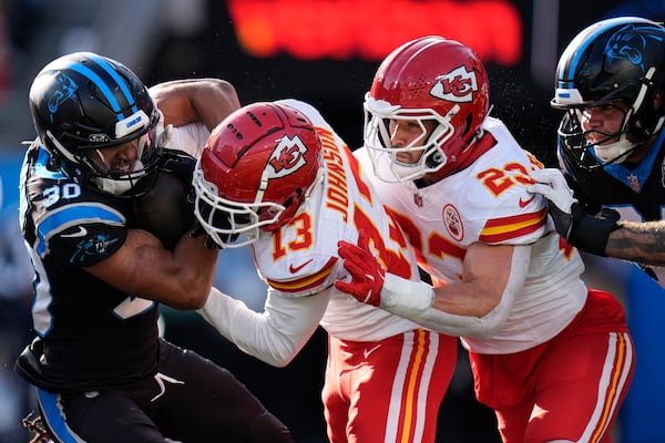 Kansas City Chiefs safety Nazeeh Johnson (13) hits Carolina Panthers running back Chuba Hubbard (30) during the second half of an NFL football game, Sunday, Nov. 24, 2024, in Charlotte, N.C. (AP Photo/Rusty Jones)