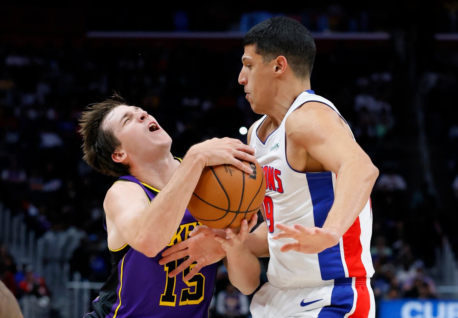 Los Angeles Lakers guard Austin Reaves (15) collides with Detroit Pistons forward Simone Fontecchio (19) while driving to the basket during the first half of an NBA basketball game Monday, Nov. 4, 2024, in Detroit. (AP Photo/Duane Burleson)