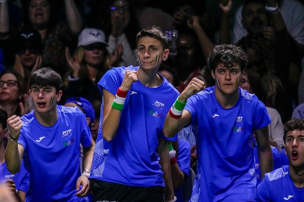 Supporters of Italy cheer during the match between Italy's Matteo Berrettini and Australia's Thanasi Kokkinakis during the Davis Cup semifinal at the Martin Carpena Sports Hall in Malaga, southern Spain, on Saturday, Nov. 23, 2024. (AP Photo/Manu Fernandez)