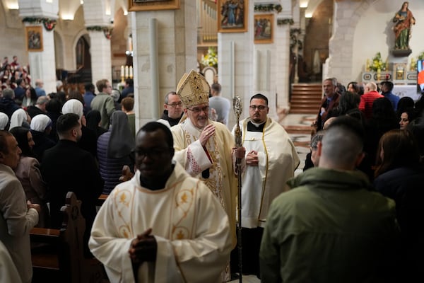 Latin Patriarch Pierbattista Pizzaballa, center, leads the Christmas morning Mass at the Chapel of Saint Catherine, traditionally believed to be the birthplace of Jesus, in the West Bank city of Bethlehem, Wednesday, Dec. 25, 2024. (AP Photo/Matias Delacroix)