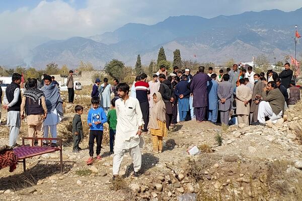 Mourners bury a body of a person killed when gunmen fired on vehicles carrying Shiite Muslims Thursday, after his funeral prayer in Parachinar, main town of Kurram district of Pakistan's northwestern Khyber Pakhtunkhwa province, Friday, Nov. 22, 2024. (AP Photo/Hussain Ali)