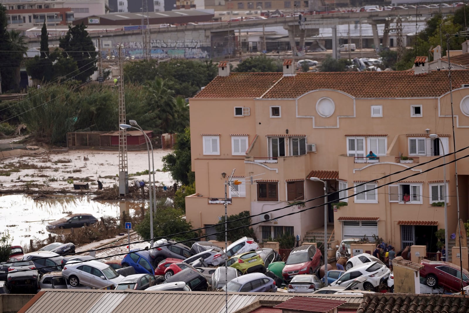 Vehicles are seen piled up after being swept away by floods in Valencia, Spain, Thursday, Oct. 31, 2024. (AP Photo/Alberto Saiz)