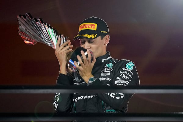 Mercedes driver George Russell, of Britain, celebrates on the podium after winning during the F1 Las Vegas Grand Prix auto race, Saturday, Nov. 23, 2024, in Las Vegas. (AP Photo/John Locher)