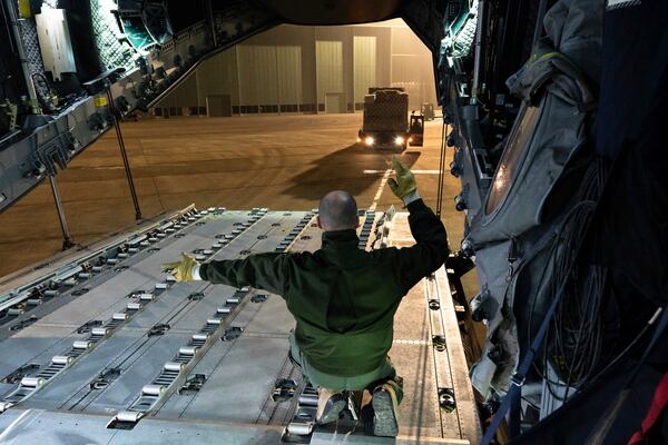 This photo provided Sunday Dec.15, 2024 by the French Army shows a soldier directing loading operations of relief for the island of Mayotte, in the Indian Ocean, after Cyclone Chido caused extensive damage with reports of several fatalities, Saturday Dec.14, 2024 in Orleans, central France. (Laure-Anne Maucorps/ Etat Major des Armées via AP)