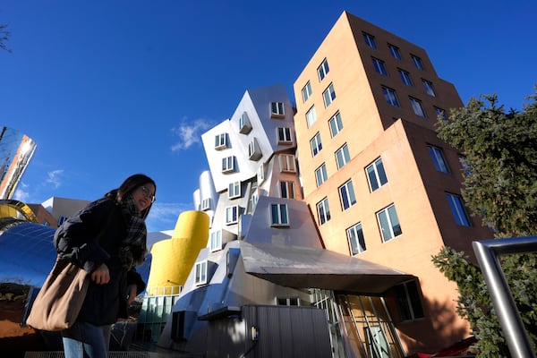 A person walks near buildings, Tuesday, Dec. 17, 2024, on the campus of Massachusetts Institute of Technology in Cambridge, Mass. (AP Photo/Steven Senne)