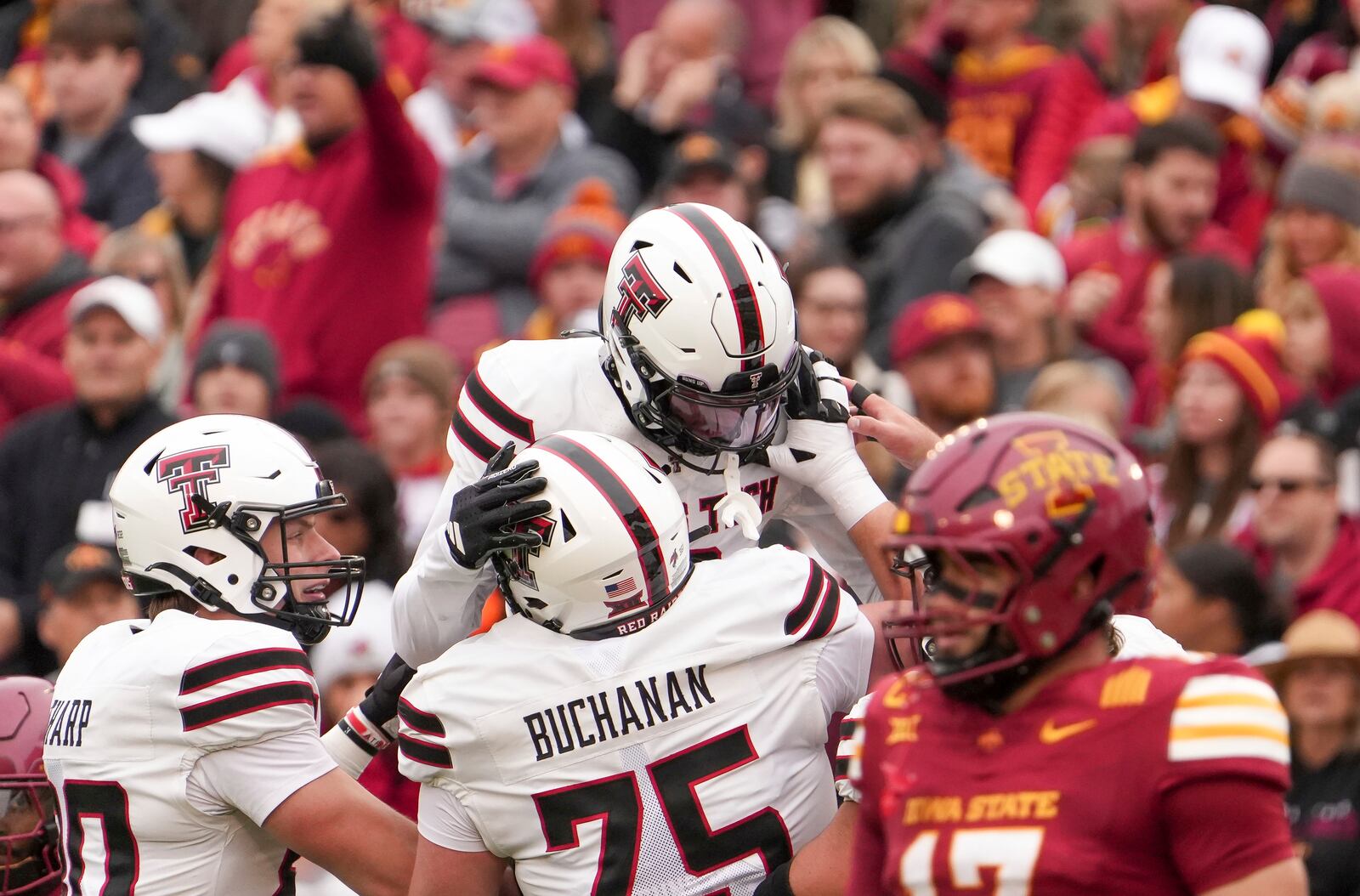 Texas Tech wide receiver Josh Kelly, top, celebrates with teammates after scoring a touchdown against Iowa State during the first half of an NCAA college football game, Saturday, Nov. 2, 2024, in Ames, Iowa. (AP Photo/Bryon Houlgrave)