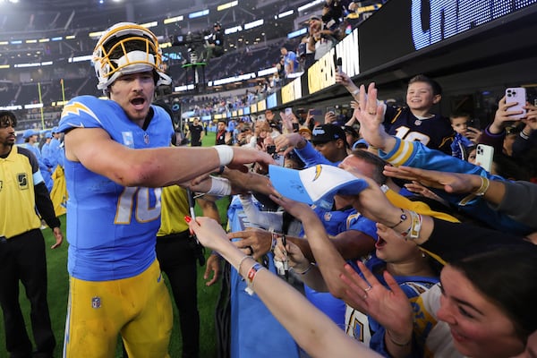 Los Angeles Chargers quarterback Justin Herbert (10) greets fans after a win over the Denver Broncos in an NFL football game Thursday, Dec. 19, 2024, in Inglewood, Calif. (AP Photo/Ryan Sun)