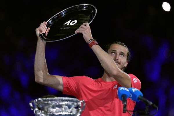 Alexander Zverev of Germany holds up his trophy after losing the men's singles final to Jannik Sinner of Italy at the Australian Open tennis championship in Melbourne, Australia, Sunday, Jan. 26, 2025. (AP Photo/Ng Han Guan)