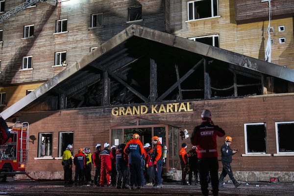 Firefighters and emergency teams work after a fire that broke out at a hotel in the ski resort of Kartalkaya, located in Bolu province, northwest Turkey, on Tuesday, Jan. 21, 2025. (AP Photo/Francisco Seco)