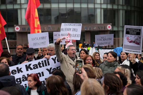 Activists chant slogans during a protest outside the courthouse where dozens of Turkish healthcare workers including doctors and nurses go on trial for fraud and causing the deaths of 10 infants, in Istanbul, Turkey, Monday Nov, 18, 2024.(AP Photo/Khalil Hamra)