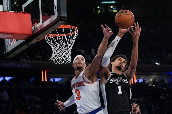 New York Knicks' Josh Hart (3), left, and San Antonio Spurs' Victor Wembanyama fight for a rebound during the second half of an NBA basketball game, Wednesday, Dec. 25, 2024, in New York. The Knicks defeated the Spurs 117-114. (AP Photo/Seth Wenig)