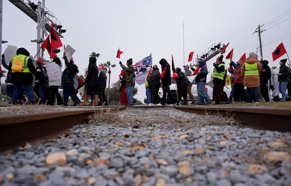 Supporters of President-elect Donald Trump honk as they past a group from La Union del Pueblo Entero (LUPE), meaning The Union of the Entire People, marching to protest the inauguration of President-elect Trump, Monday, Jan. 20, 2025, in McAllen, Texas. (AP Photo/Eric Gay)