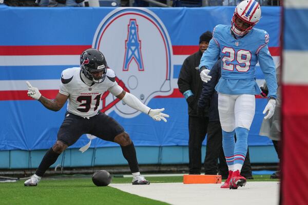 Houston Texans running back Dameon Pierce (31) celebrates after a 92-yard touchdown run as Tennessee Titans cornerback Jarvis Brownlee Jr. (29) looks down during the first half of an NFL football game Sunday, Jan. 5, 2025, in Nashville, Tenn. (AP Photo/George Walker IV)