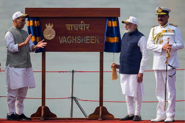 From right to left, India's Navy Chief Dinesh Kumar Tripathi, Indian Prime Minister Narendra Modi, and Indian Defense Minister Rajnath Singh, are seen on the deck of submarine Vaghsheer during its commissioning ceremony at a naval dockyard in Mumbai, India, Wednesday, Jan. 15, 2025. (AP Photo/Rafiq Maqbool)