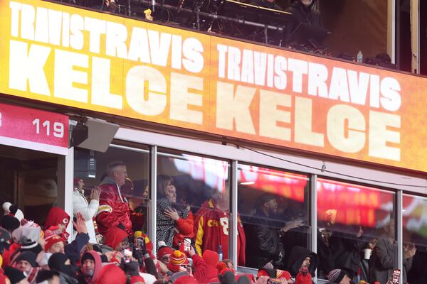 Taylor Swift hugs Caitlin Clark, right, as they celebrate with Swift's father, Scott Swift, left, following a touchdown by Kansas City Chiefs tight end Travis Kelce during the second half of an NFL football AFC divisional playoff game between the Kansas City Chiefs and the Houston Texans Saturday, Jan. 18, 2025, in Kansas City, Mo. (AP Photo/Travis Heying)