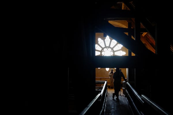 People stand inside Notre-Dame Cathedral in Paris, Friday Nov. 29 2024 before French President Emmanuel Macron's final visit to the construction site to see the restored interiors before the iconic monument's reopening for worship on Dec. 8. (Sarah Meyssonnier, Pool via AP)