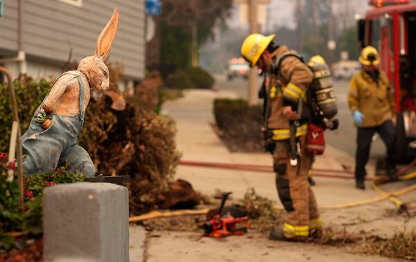 A firefighter looks at charred remains outside the destroyed Bunny Museum, Thursday, Jan. 9, 2025, in the Altadena section of Pasadena, Calif. (AP Photo/Chris Pizzello)