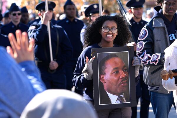 Garland High School senior Saron Lias waves while marching in the 36th annual Dr. Martin Luther King Jr. Parade in Garland, Texas, Saturday, Jan. 18, 2025. (AP Photo/LM Otero)