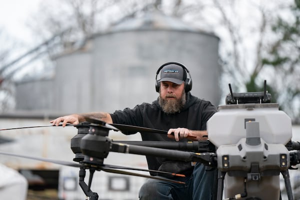 Russell Hedrick prepares a DJI drone to put crop cover on his farm, Tuesday, Dec. 17, 2024, in Hickory, N.C. (AP Photo/Allison Joyce)