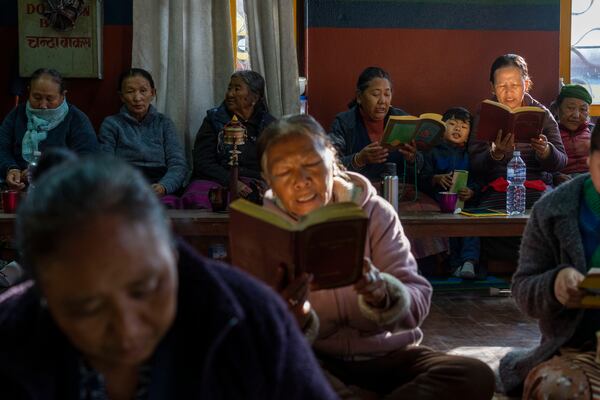 Tibetan people gather to offer prayers in remembrance of those who lost their lives in the recent earthquake, at a Tibetan camp in Lalitpur, Nepal, on Wednesday, Jan. 8, 2025. (AP Photo/Niranjan Shrestha)