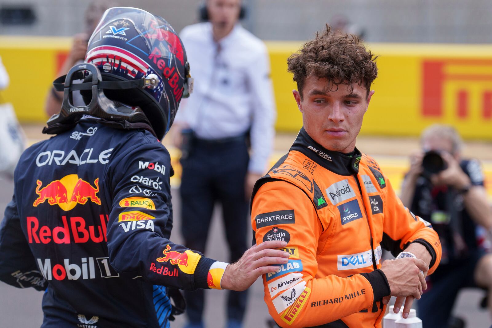 McLaren driver Lando Norris, of Britain, right is congratulated by Red Bull driver Max Verstappen, of the Netherlands, left, following sprint race ahead of the Formula One U.S. Grand Prix auto race at Circuit of the Americas, Saturday, Oct. 19, 2024, in Austin, Texas. (AP Photo/Nick Didlick)